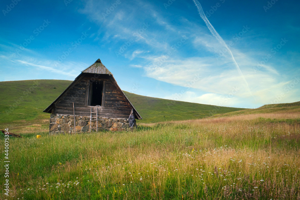 Amazing green field, pastures, mountain road and small farmer hut in the hills of Zlatibor resort in Western Serbia
