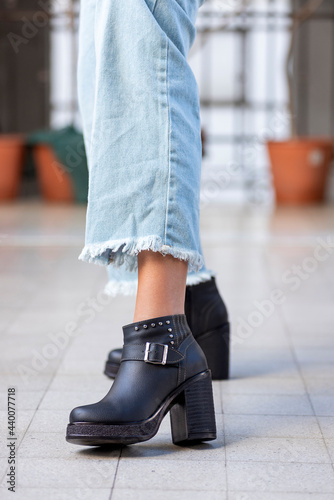 woman legs wearing brown black leather fashion shoes with casual clothes with very stylish bottom