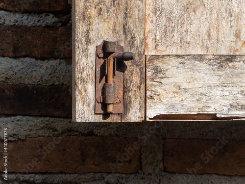 brown wooden door opens with latch lock. very classic and attractive.