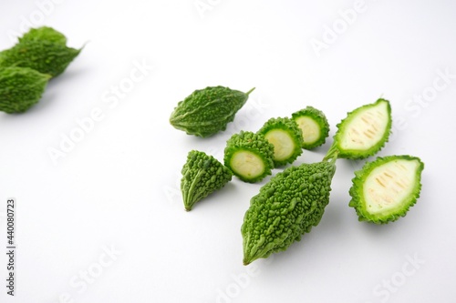 Green bitter gourd fruit isolated from white table background