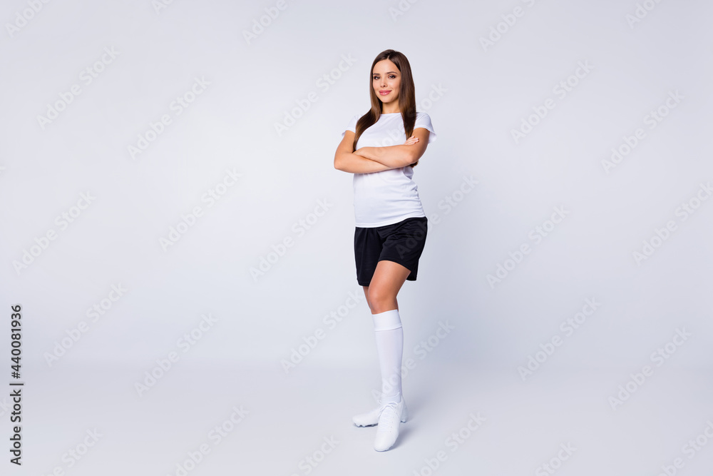 Full length photo of attractive lady arms crossed self-confident skilled player soccer women team wear football uniform t-shirt shorts long socks boots isolated white color background Full length photo of attractive lady arms crossed self-confident skilled player soccer women team wear football uniform t-shirt shorts long socks boots isolated white color background