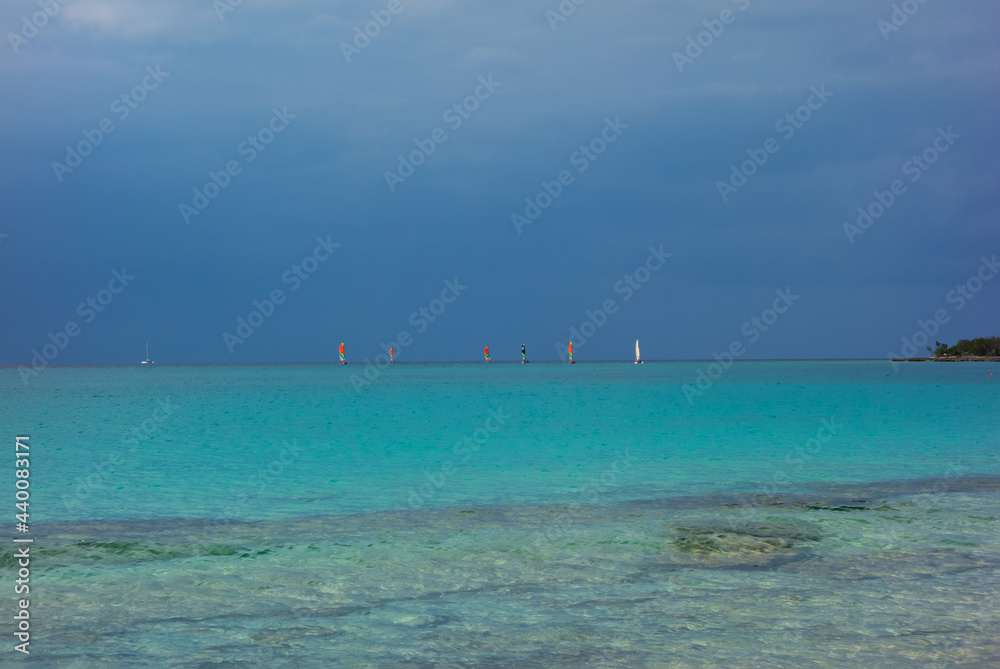 storm clouds approaching beach with blue sea