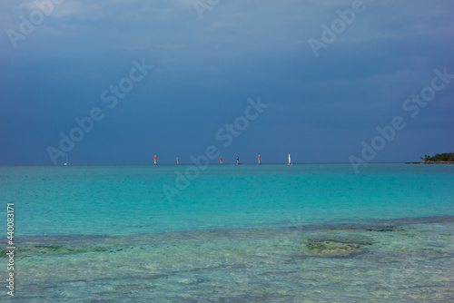 storm clouds approaching beach with blue sea