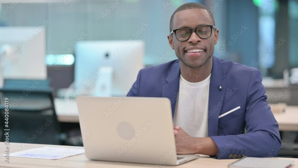 African Businessman with Laptop Smiling at Camera African Businessman with Laptop Smiling at Camera