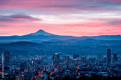 A colorful, pink sunrise with Mt. Hood and Portland, Oregon featuring a lenticular cloud over Mt Hood