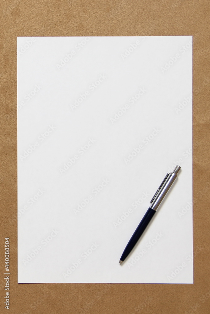 Template of white paper with pen lies on light brown cloth background. Concept of business plan and strategy. Stock photo with empty space for text and design. Template of white paper with pen lies on light brown cloth background. Concept of business plan and strategy. Stock photo with empty space for text and design.