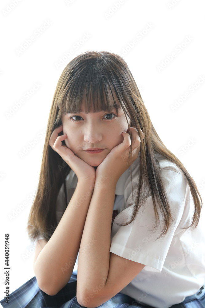 Portrait japanese school girl uniform sitting and look at camera in white tone bed room Portrait japanese school girl uniform sitting and look at camera in white tone bed room