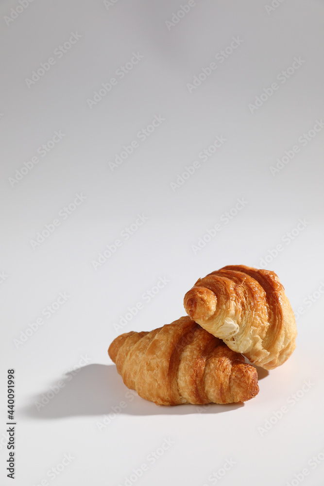 Croissant isolated in  wihite background with sunny light
