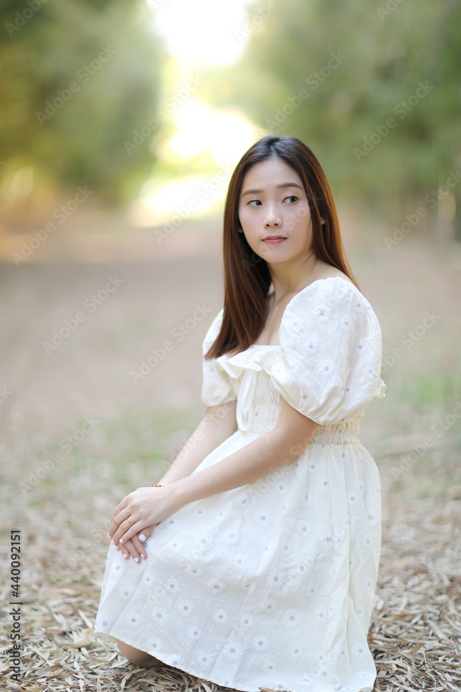Beautiful young woman with white dress on bamboo forest background Beautiful young woman with white dress on bamboo forest background