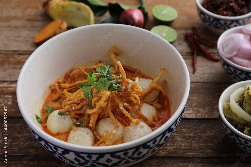 Local northern Thai food Egg noodle curry with meatballs on wood background Local northern Thai food Egg noodle curry with meatballs on wood background