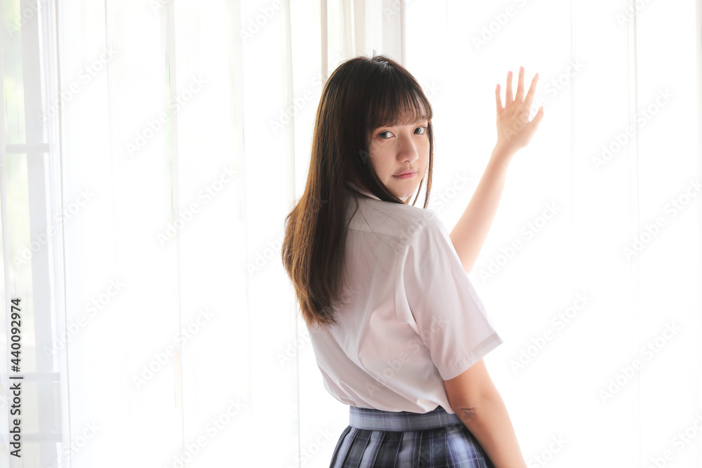 Portrait japanese school girl uniform in white tone bed room Portrait japanese school girl uniform in white tone bed room