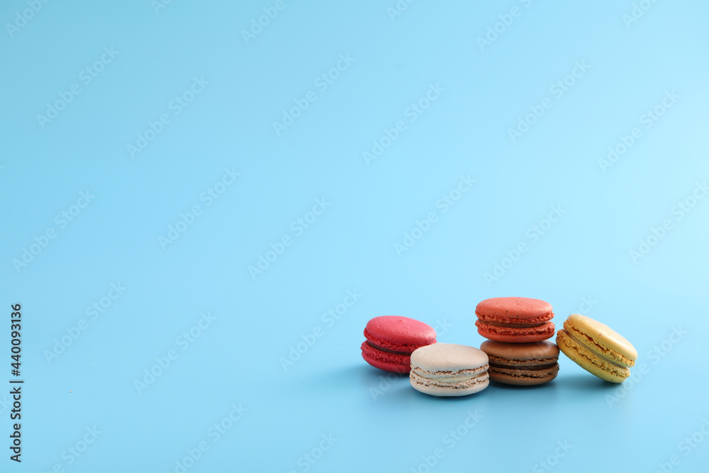 Colorful macarons isolated in blue background Colorful macarons isolated in blue background