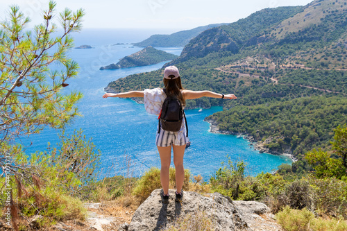 woman tourist enjoy the view of the Mediterranean sea over mountain top, Oludeniz, Turkey