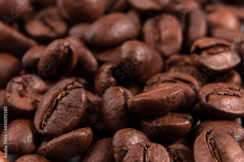 pile of arabica coffee beans close-up. macro shot  selective focus  dark background