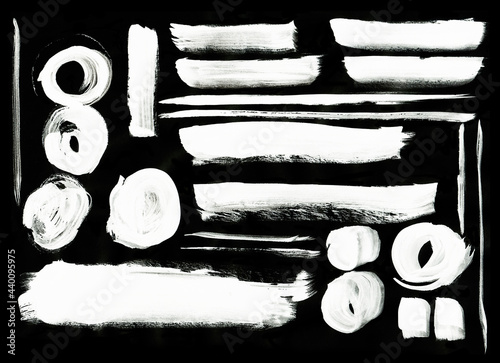Grunge white splashes isolated on a black background. Texture shape for design. Abstract art drawing. Watercolor handwork collection.