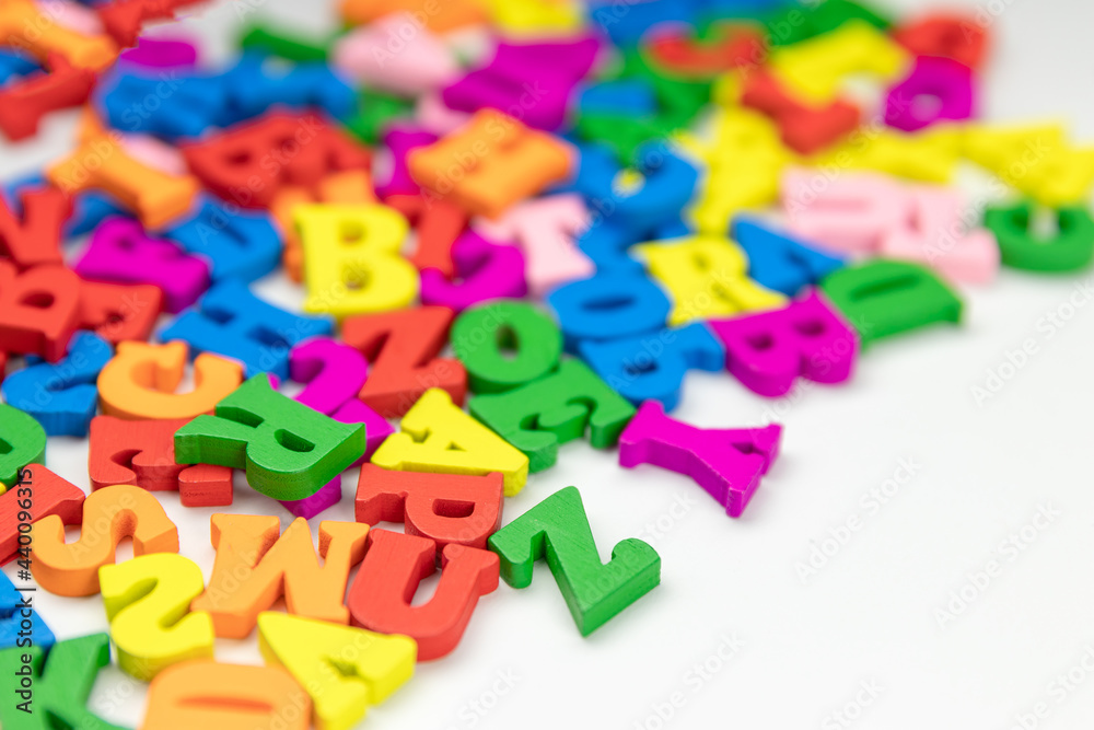 colored wooden letters of the english alphabet on a white background, copy space colored wooden letters of the english alphabet on a white background, copy space