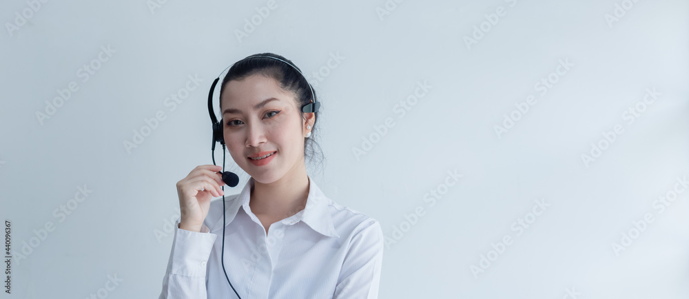 Asian woman business operator with microphone at work, Call center, support telemarketing at white background. crop image banner. Asian woman business operator with microphone at work, Call center, support telemarketing at white background. crop image banner.