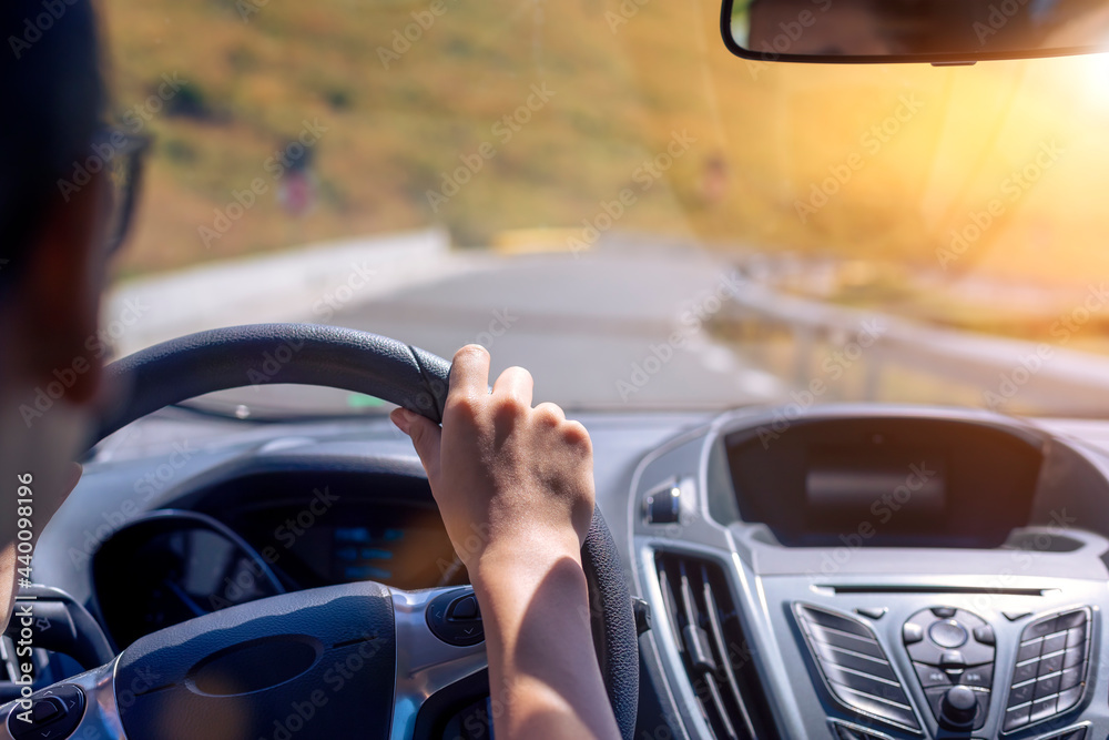 Girl hands on the steering wheel of a car while driving Girl hands on the steering wheel of a car while driving
