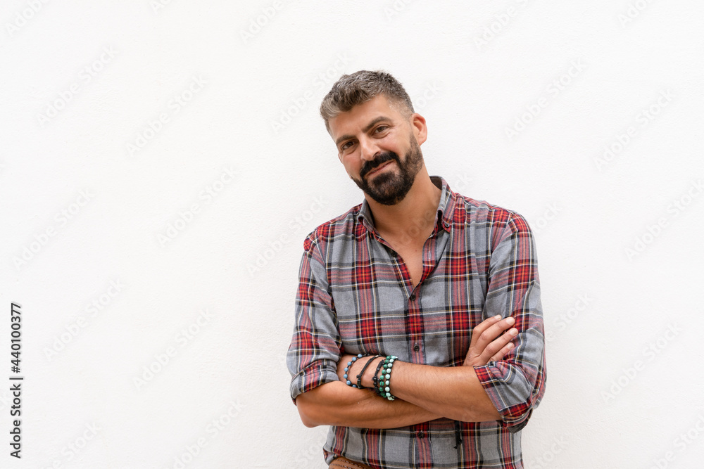 Portrait of smiling man standing with crossing arms looking to the camera on white background. Portrait of smiling man standing with crossing arms looking to the camera on white background.