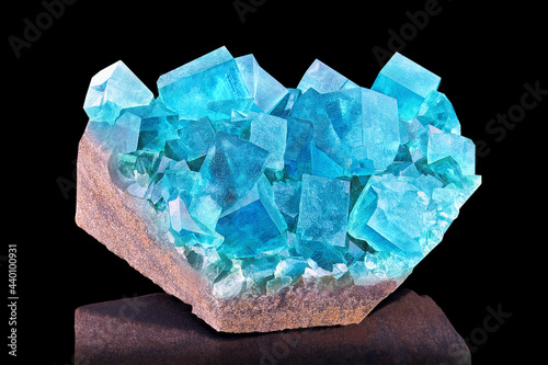 Vászonkép Amazing colorful macro closeup of aqua blue rare fluorite mineral specimen isolated on black background