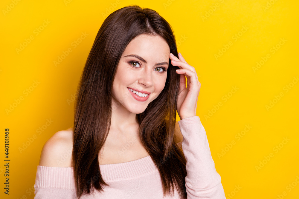 Photo of optimistic brunette lady hands hair wear pink shirt isolated on yellow color background Photo of optimistic brunette lady hands hair wear pink shirt isolated on yellow color background