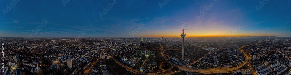 Fototapeta premium Panoramic drone image of the Frankfurt skyline with television tower in the evening during a colorful and impressive sunset