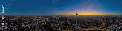 Panoramic drone image of the Frankfurt skyline with television tower in the evening during a colorful and impressive sunset