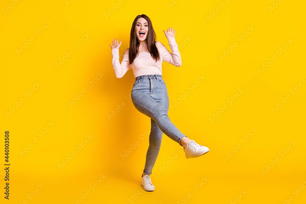 Full size photo of young beautiful funky funny cheerful excited amazed woman dancing isolated on yellow color background