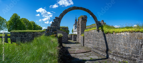 Gudhem Historical Monastery Ruin and Church in rural environment with overgrown stone walls and arches during Summer near Falkoping Vastra Gotaland, Sweden. photo