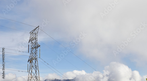 A light antenna in a sunny landscape with clouds in the background