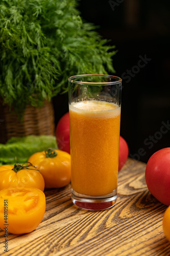 Tomato juice, on a children's table, near the green and yellow and red tomatoes 