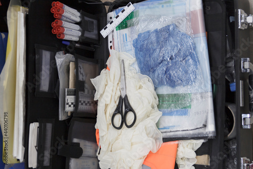 Tool inspector criminalist for fingerprints at crime scene photo