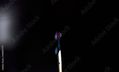Matchstick about to go out with black background