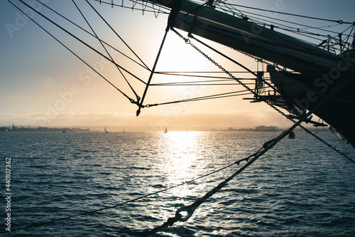 Sunset behind the silhouette of a sailboat in San Diego photo