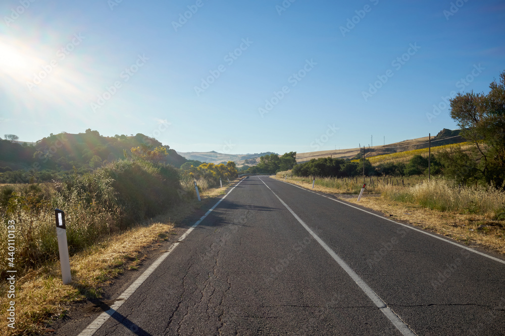 road between the landscape of central sicily in full summer