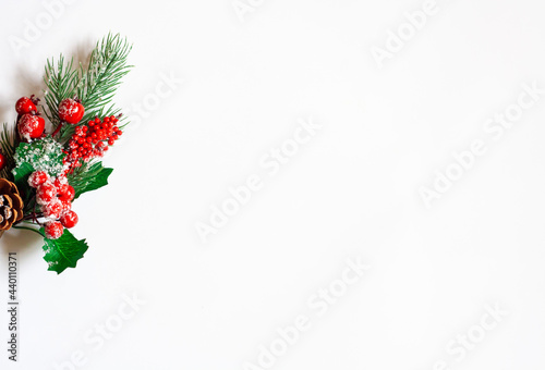 Christmas background, spruce twig with red berries on a white background, copy space
