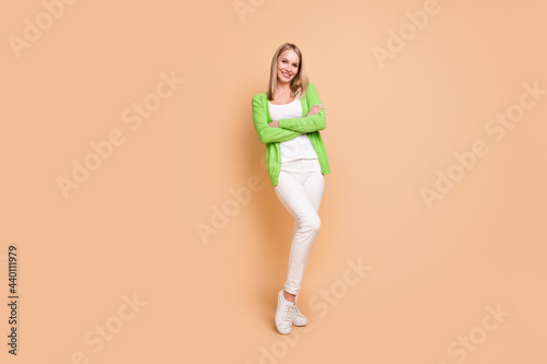 Full length body size photo business woman with crossed hands smiling isolated pastel beige color background copyspace