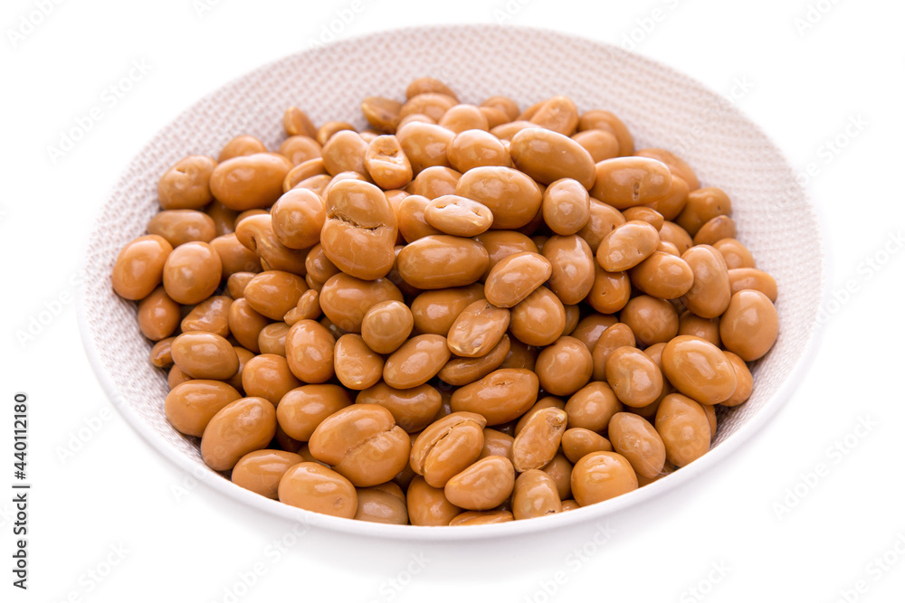 groundnut in caramel glaze in a white dish on a white background . Isolated items and products. groundnut in caramel glaze in a white dish on a white background . Isolated items and products.