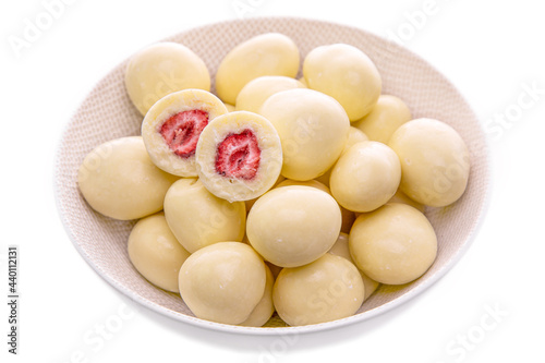 strawberries in white chocolate in a light plate on a white background. isolated foods in a white dish on a white background . Isolated items and products.