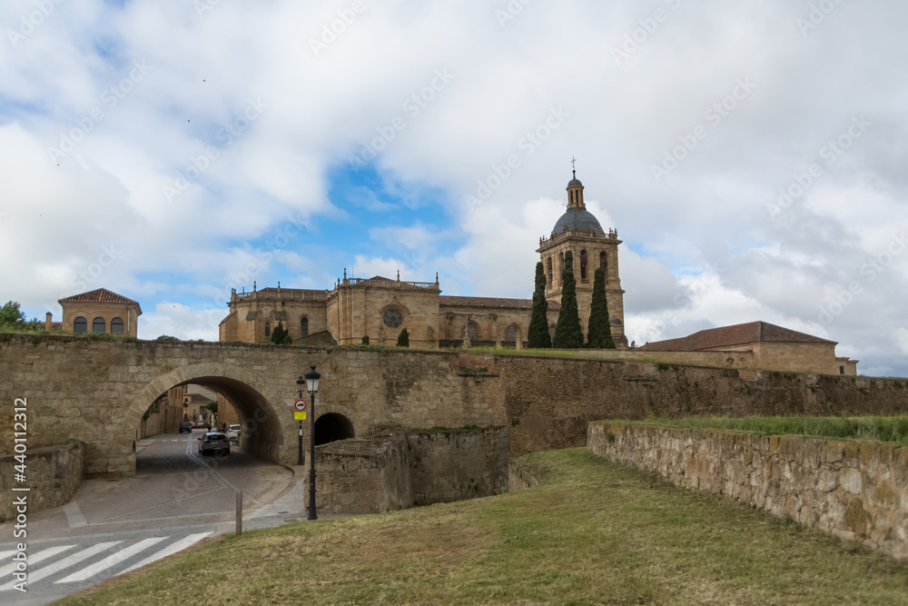 Majestic front view at the fortress gate and iconic spanish Romanesque architecture building at the Cuidad Rodrigo cathedral, towers and domes, downtown city