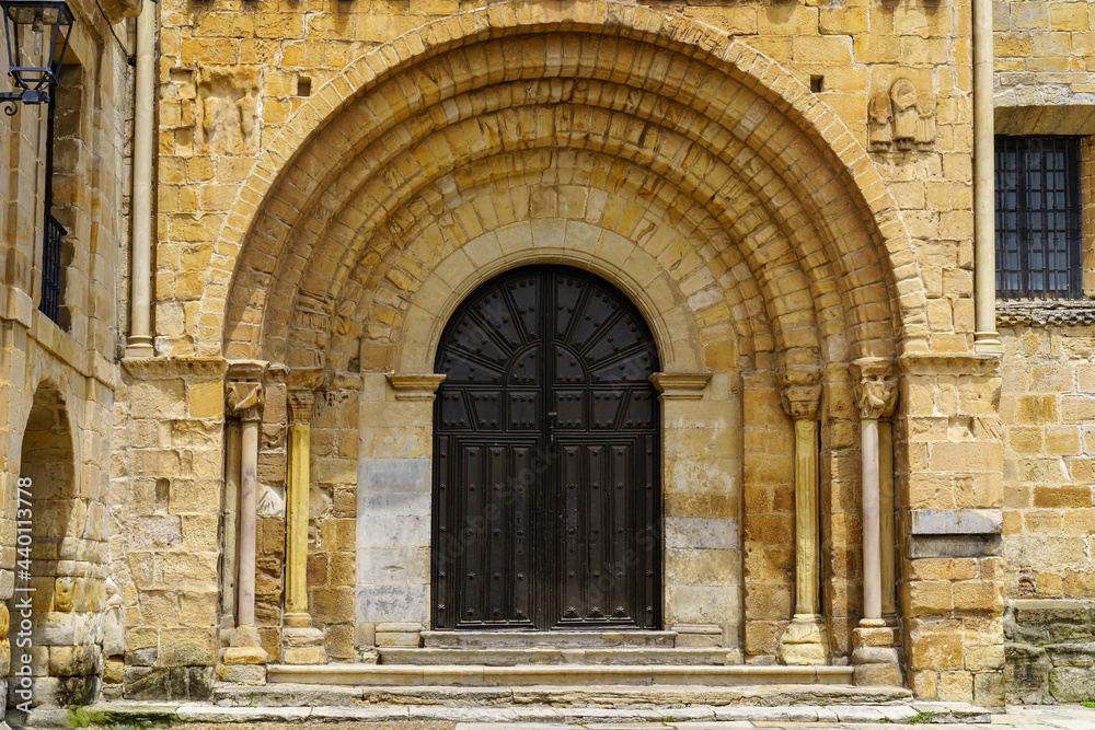 Arched main door, entrance to an old Romanesque church in northern Spain. Santillana del Mar.