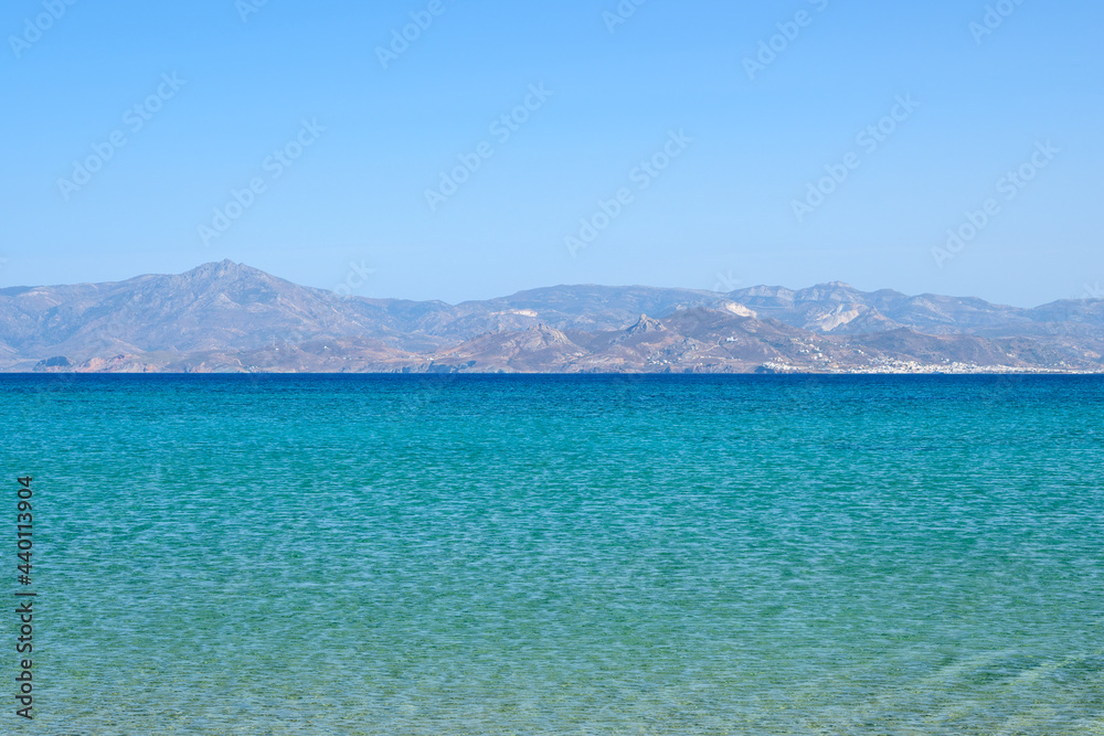Santa Maria beach with emerald waters and view on the island of Naxos. The best beach of Paros. Cyclades, Greece