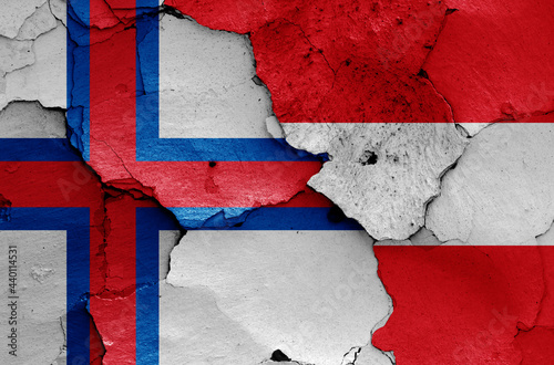 flags of Faroe Islands and Austria painted on cracked wall