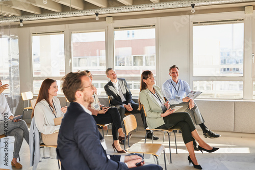 Male and female colleagues attending educational training class at office