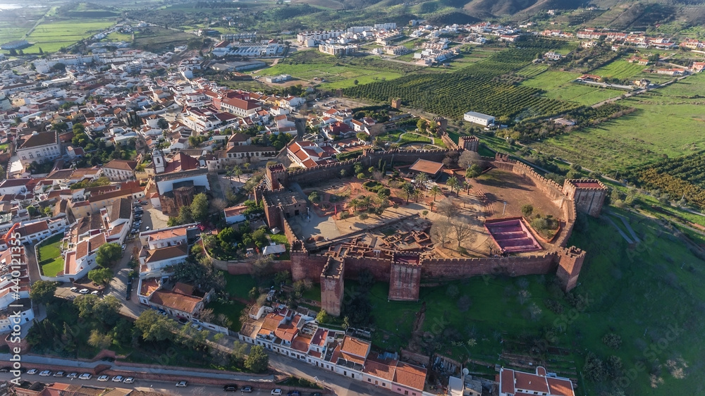 The Portuguese historic village of Silves, Algarve Alentejo zone, view from the sky, aerial. Fortress and church in the foreground.