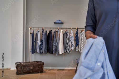 Shirts hanging on rack in clothes design studio photo