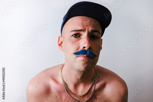 Man with mustache wearing cap against white background photo