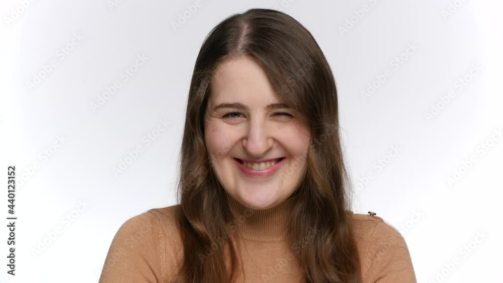 Portrait of smiling young woman looking in camera and winking with eye. Portrait of smiling young woman looking in camera and winking with eye.