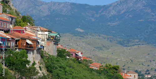 Bars and restaurants of the village of Molyvos clinging  to the hillside with backdrop of mountains.  © harlequin9