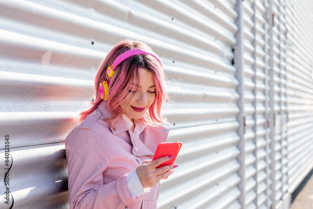 Smiling woman using mobile phone during sunny day Smiling woman using mobile phone during sunny day